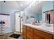 Bathroom with double sinks, shower, and a large vanity at 14308 Tugwell Ave, Port Charlotte, FL 33953