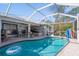 Inviting screened pool area with a kidney-shaped pool at 14308 Tugwell Ave, Port Charlotte, FL 33953