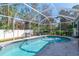 Inviting screened-in pool with surrounding patio at 14308 Tugwell Ave, Port Charlotte, FL 33953