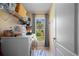 Bright laundry room with washer, dryer, and ample shelving at 14308 Tugwell Ave, Port Charlotte, FL 33953