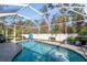 Inviting screened pool area with a kidney-shaped pool at 14308 Tugwell Ave, Port Charlotte, FL 33953