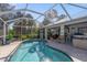 Inviting screened pool area with a kidney-shaped pool at 14308 Tugwell Ave, Port Charlotte, FL 33953