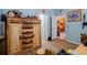 Bedroom with a large rustic wooden dresser and light blue walls at 14308 Tugwell Ave, Port Charlotte, FL 33953