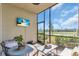 Screened patio with seating area and golf course view at 18008 Gawthrop Dr # 108, Bradenton, FL 34211