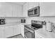 Modern kitchen with stainless steel appliances and white cabinets at 18008 Gawthrop Dr # 108, Bradenton, FL 34211