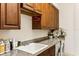 Well-appointed laundry room with ample counter and cabinet space at 9452 Swaying Branch Rd, Sarasota, FL 34241