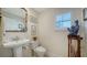 Elegant powder room with pedestal sink and decorative mirror at 1713 Starling Dr # 1713, Sarasota, FL 34231