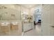 Spa-like bathroom with a walk-in shower, double vanity, and view into the bedroom at 1713 Starling Dr # 1713, Sarasota, FL 34231