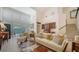 Spacious living room with a cream sofa, large windows and high ceilings at 1713 Starling Dr # 1713, Sarasota, FL 34231