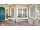Front entry with teal door, window boxes, and brick flooring at 1713 Starling Dr # 1713, Sarasota, FL 34231