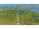 Aerial view of lush mangrove preserve with walking path and waterway access at 1713 Starling Dr # 1713, Sarasota, FL 34231