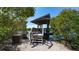 Wooden gazebo overlooking the calm waters with seating and steps at 1713 Starling Dr # 1713, Sarasota, FL 34231