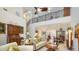 Open living area with high ceilings, comfortable seating, and a view of the dining area at 1713 Starling Dr # 1713, Sarasota, FL 34231