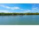 Tranquil waterway scene with a boat and lush vegetation at 1713 Starling Dr # 1713, Sarasota, FL 34231