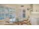 Charming kitchen nook with glass table and woven chairs at 1713 Starling Dr # 1713, Sarasota, FL 34231