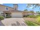 Front view of two-story townhome with attached garage and landscaping at 1713 Starling Dr # 1713, Sarasota, FL 34231