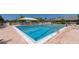 Inviting community pool with ample seating and shade at 1713 Starling Dr # 1713, Sarasota, FL 34231