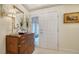 Elegant entryway with a wood dresser and mirror at 1713 Starling Dr # 1713, Sarasota, FL 34231