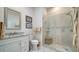 Modern bathroom with walk-in shower and granite vanity at 1713 Starling Dr # 1713, Sarasota, FL 34231