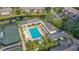 Aerial view of community pool, tennis courts, and lush landscaping at 1713 Starling Dr # 1713, Sarasota, FL 34231