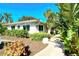 White building with tropical landscaping and walkway at 9393 Midnight Pass Rd # 503, Sarasota, FL 34242