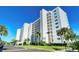 White multi-story building with lush landscaping at 9393 Midnight Pass Rd # 503, Sarasota, FL 34242