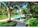 Peaceful waterfront pathway with a bench for relaxing at 9393 Midnight Pass Rd # 503, Sarasota, FL 34242