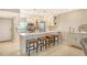 Eat-in kitchen with breakfast bar, stainless steel appliances, and white cabinets at 9393 Midnight Pass Rd # 503, Sarasota, FL 34242