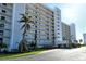 White multi-story building with palm trees at 9393 Midnight Pass Rd # 503, Sarasota, FL 34242