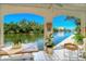 Covered waterfront patio with table and chairs at 9393 Midnight Pass Rd # 503, Sarasota, FL 34242