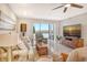 Living room with water view, comfortable seating, and large screen TV at 9393 Midnight Pass Rd # 503, Sarasota, FL 34242