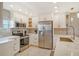 Updated kitchen featuring stainless steel appliances and white cabinetry at 9393 Midnight Pass Rd # 503, Sarasota, FL 34242