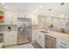 Stylish kitchen with stainless steel appliances and white shaker cabinets at 9393 Midnight Pass Rd # 503, Sarasota, FL 34242