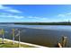 Stunning water view with palm trees and a dock at 9393 Midnight Pass Rd # 503, Sarasota, FL 34242