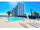 Community pool with plenty of lounge chairs at 9393 Midnight Pass Rd # 503, Sarasota, FL 34242