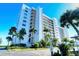 White building exterior with palm trees and waterfront view at 9393 Midnight Pass Rd # 503, Sarasota, FL 34242