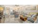 Bright living room featuring comfortable seating and a large screen TV at 9393 Midnight Pass Rd # 503, Sarasota, FL 34242