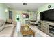 Spacious living room with a view into the kitchen and access to patio at 6041 Lilli Way # 72, Bradenton, FL 34207