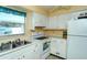 Cozy kitchen with white cabinets and view of the backyard at 6041 Lilli Way # 72, Bradenton, FL 34207
