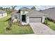 Single-Gathering home with gray siding and a paved driveway at 12584 Wellen Golf St, Venice, FL 34293