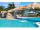 Luxury pool with waterfall and umbrellas providing shade at 17825 Gawthrop Dr # 103, Bradenton, FL 34211