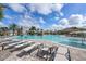 Community pool with waterfall feature, lounge chairs, and a covered seating area at 17825 Gawthrop Dr # 103, Bradenton, FL 34211