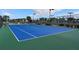 Well-maintained tennis court with blue surface at 17825 Gawthrop Dr # 103, Bradenton, FL 34211