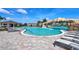 Relaxing community pool with a waterfall and plenty of lounge chairs at 17825 Gawthrop Dr # 103, Bradenton, FL 34211