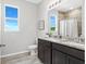 Double vanity bathroom with granite countertops and a shower/tub combo at 27059 Curitiba Dr, Punta Gorda, FL 33983