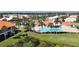 Resort-style pool with palm trees and surrounding homes at 4382 Madeira Ct # 3361, Sarasota, FL 34233