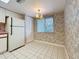 Bright dining area with floral wallpaper and a window view at 4382 Madeira Ct # 3361, Sarasota, FL 34233