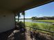 Relaxing screened patio overlooking a tranquil lake and lush landscape at 8191 Varenna Dr, Sarasota, FL 34231
