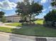 Tan two-car garage villa with lush landscaping and paved driveway at 8191 Varenna Dr, Sarasota, FL 34231