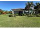 House exterior showcasing a screened patio and lush landscaping at 8191 Varenna Dr, Sarasota, FL 34231